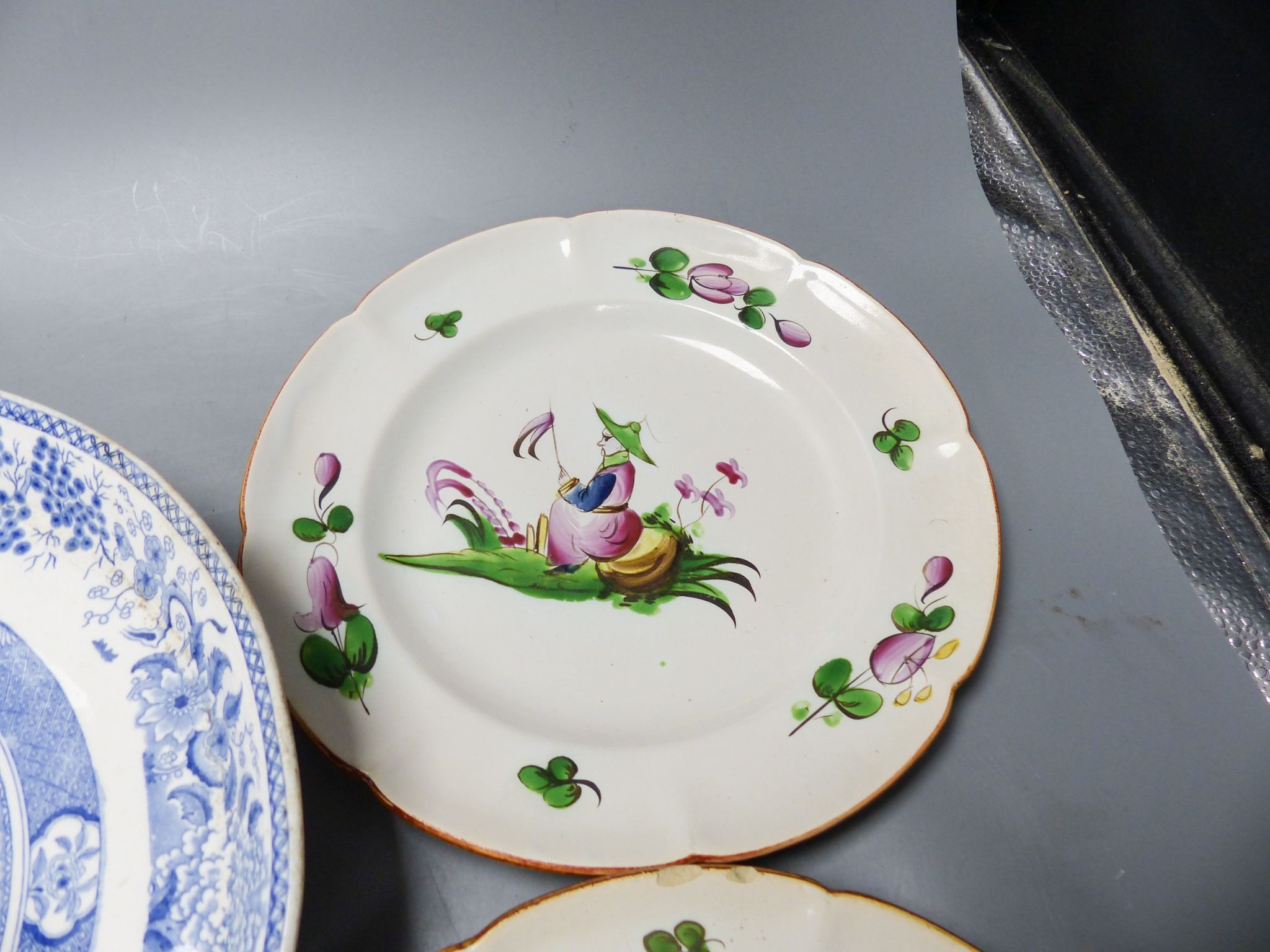 An ironstone cheese stand and a pair of French faience plates 30cm